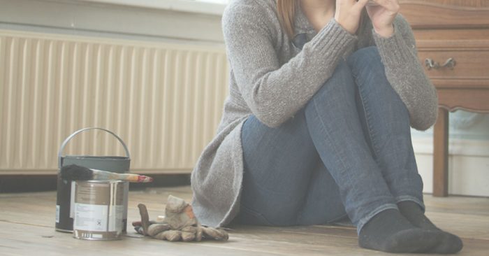 Learn to Love your home: Image of a woman sitting next to paint supplies.