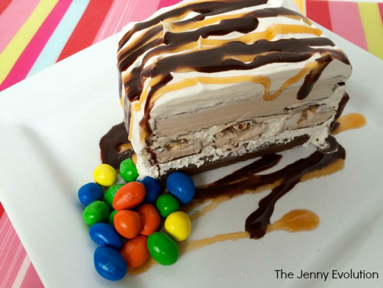Ice cream cake made with snickers ice cream bars cut in half to show the layers