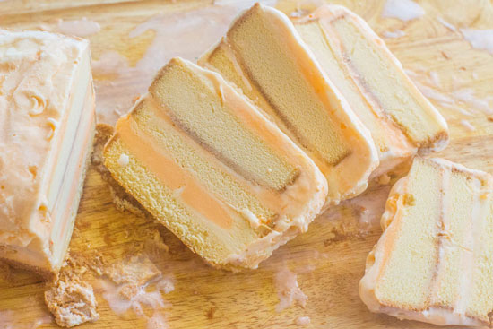 Slices of orange creamsicle inspired ice cream cake