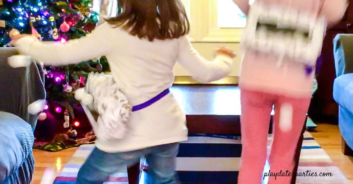 Girls Playing a winter-themed version of Minute to Win It Junk in the Trunk Game called Freezer Bum