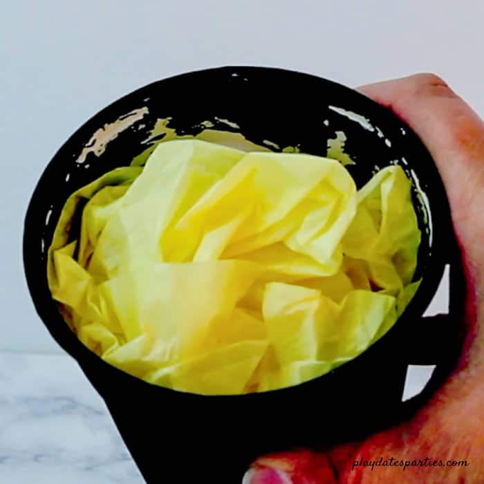 Add gold or yellow tissue paper to the inside of the cups so you don't need as much candy filler.