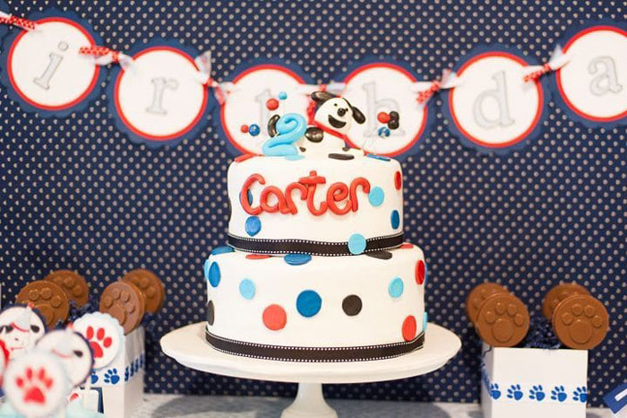 A 3-layer red white and blue puppy themed birthday cake with polka dots
