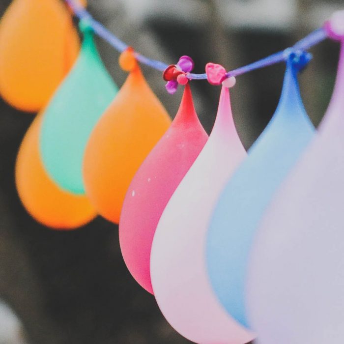 water balloons hanging from a string as a party decoration and activity