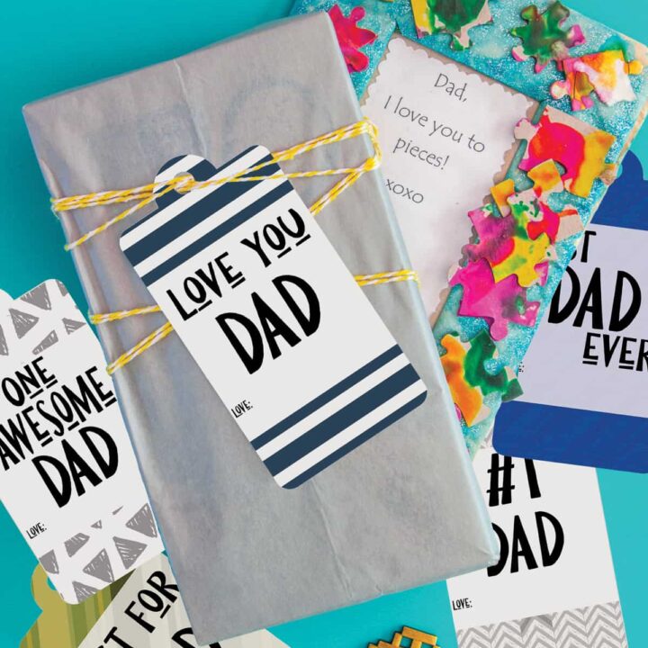 father's day gift tags scattered around gifts on a blue surface