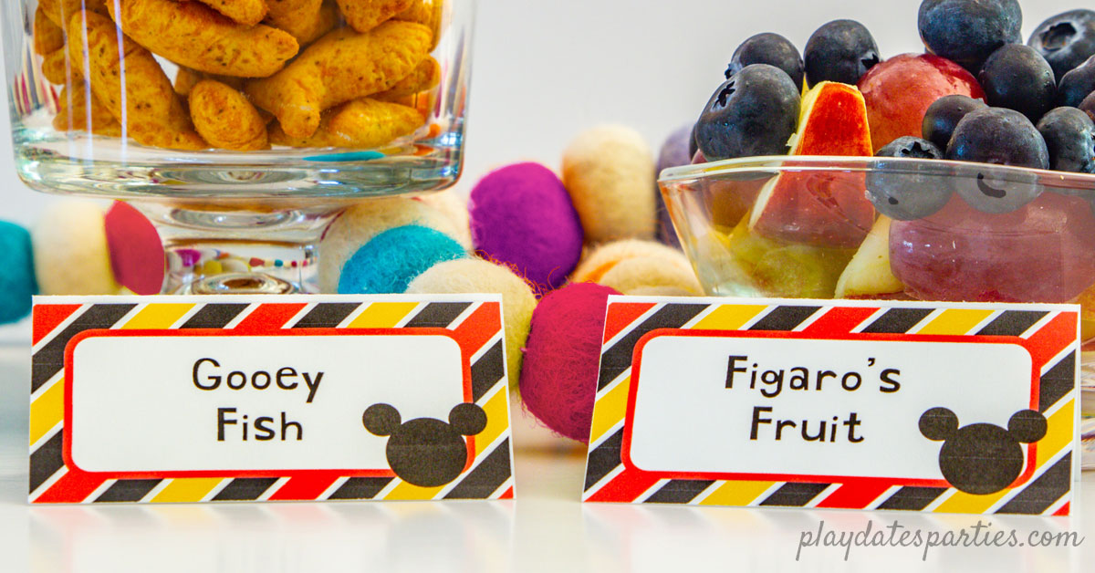 Mickey Mouse food tents with the names Gooey Fish and Figaro Fruit