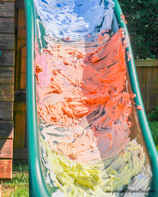 A slide covered with blue, orange, and yellow shaving cream