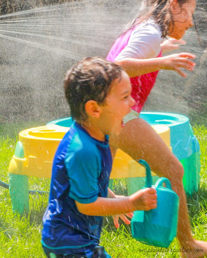 Children playing around a water table