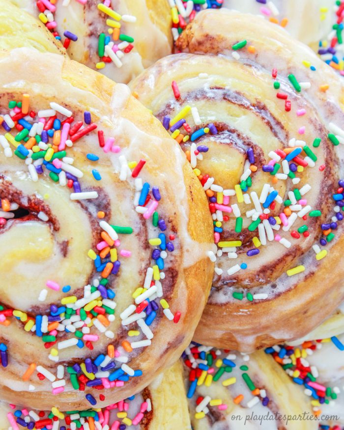 Close up of cinnamon rolls turned into a birthday cake with sprinkles