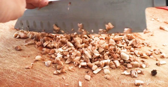 chopping the mushroom stems for stuffed mushrooms