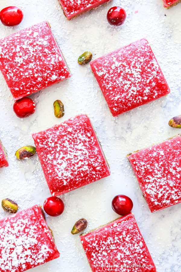 Overhead view of cranberry curd bars sprinkled with powdered sugar