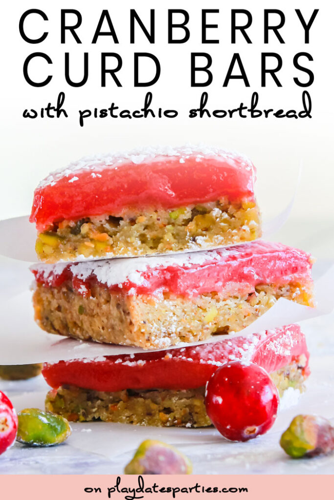 Side view of cranberry curd bars with pistachio shortbread crust