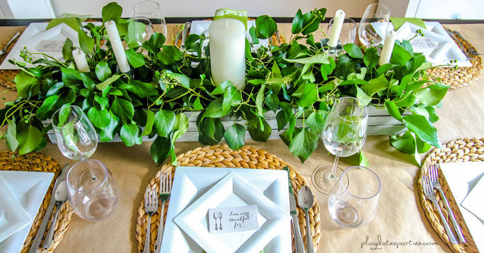 Inexpensive Thanksgiving table decor includes brown paper tablecloths, and reusable items such as woven placemats and wood boxes.