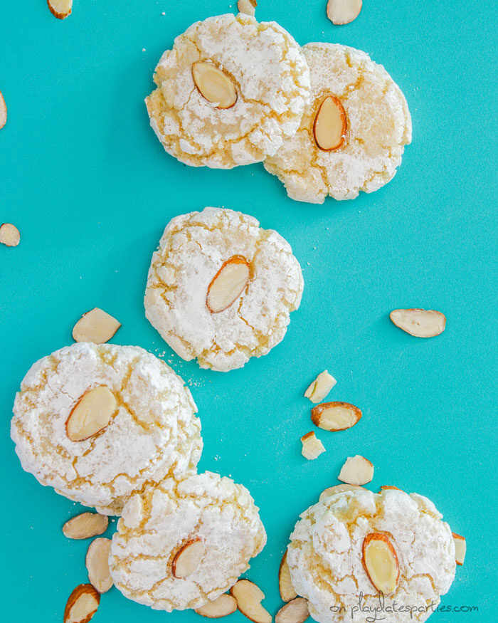 Almond macaroons scattered on a blue background