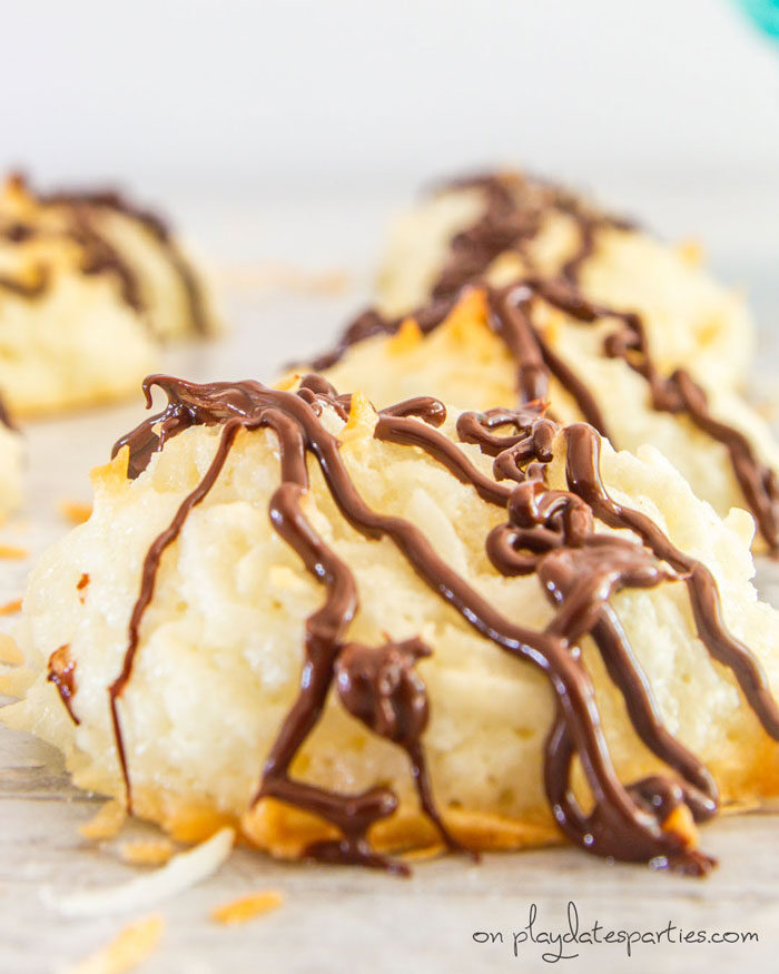 Side view of coconut macaroon drizzled with chocolate