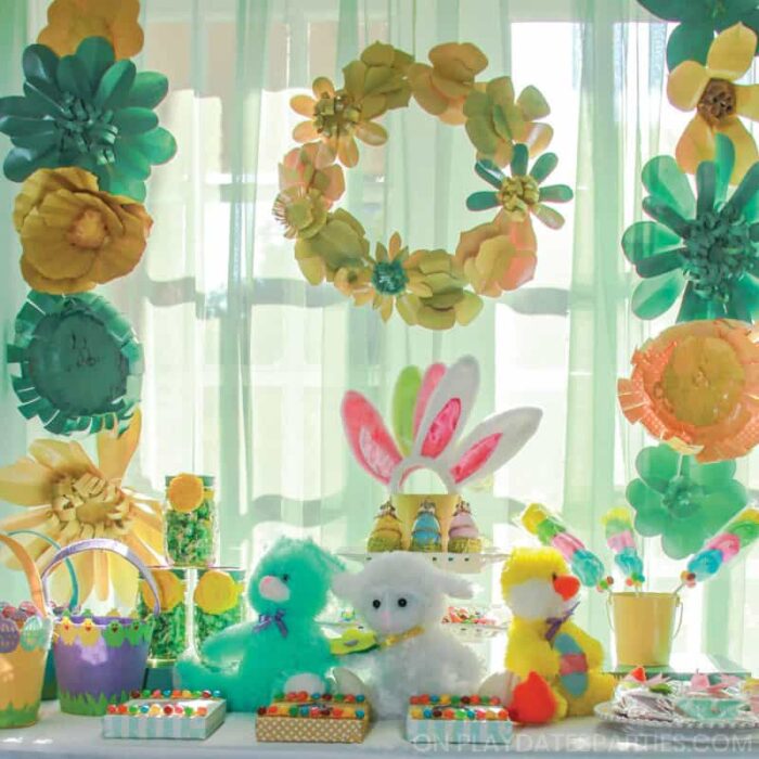 Easter treats on a table with a paper flower backdrop