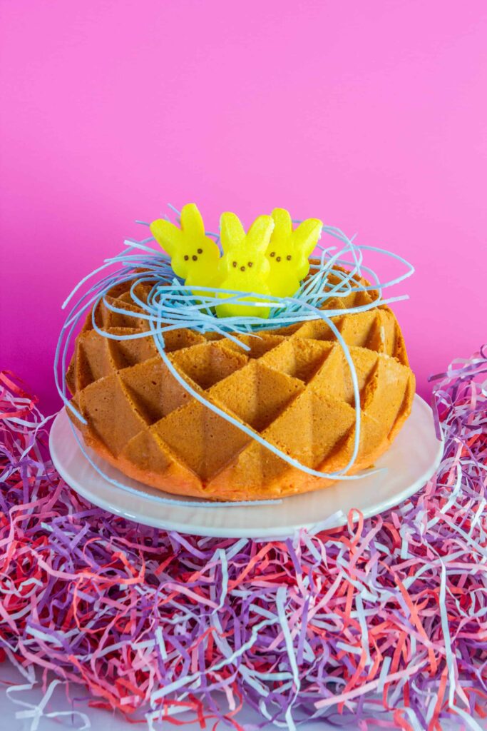 Bundt cake with peeps marshmallows in a nest on top