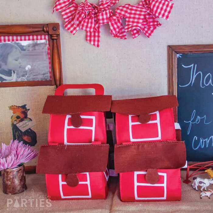 felt barn favor boxes for a farm party with a red gingham mini bunting above