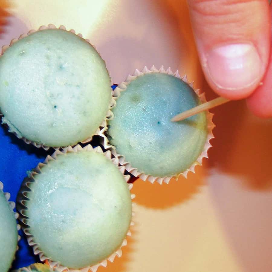 poking mini cupcake with a toothpick
