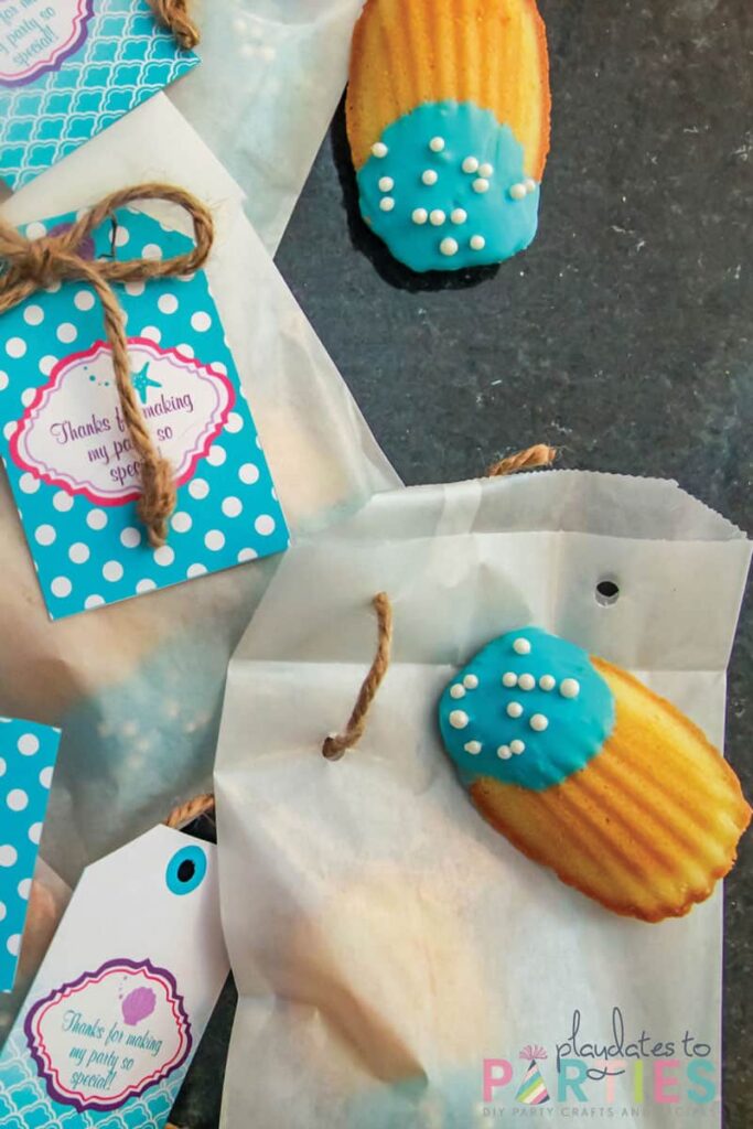 madeline cookies dipped in blue chocolate with pearl sprinkles