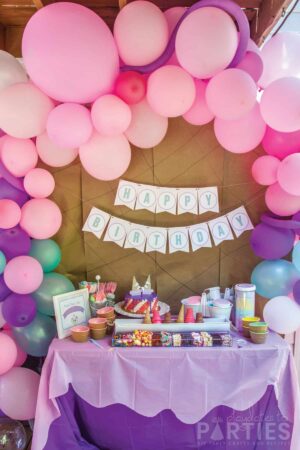 birthday party with pink purple and teal balloons