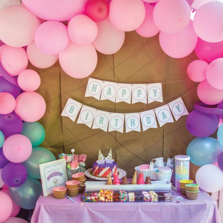 birthday party with pink purple and teal balloons