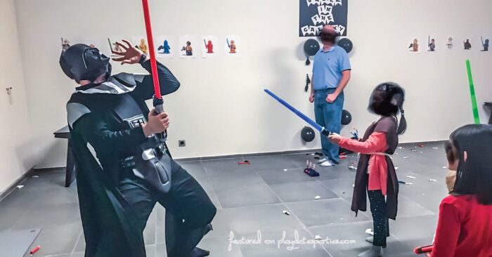 playing light saber fights at a birthday party with Darth Vader