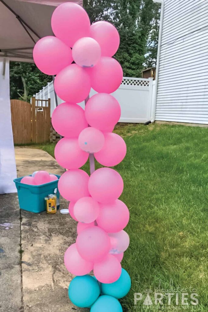 pink balloons decorating the leg of a party tent.