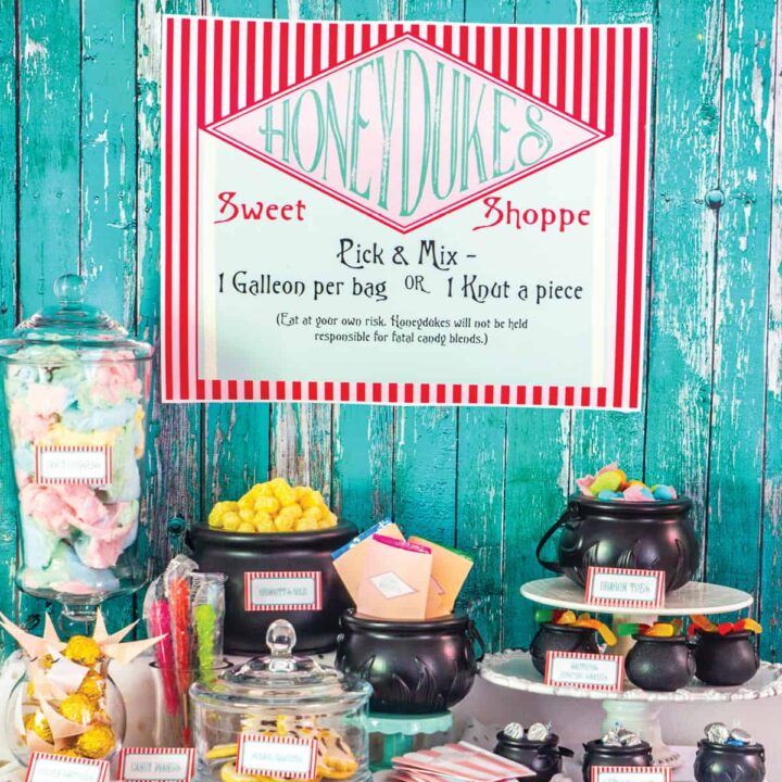 A dessert table decorated for a Harry Potter party with a HoneyDukes sign.
