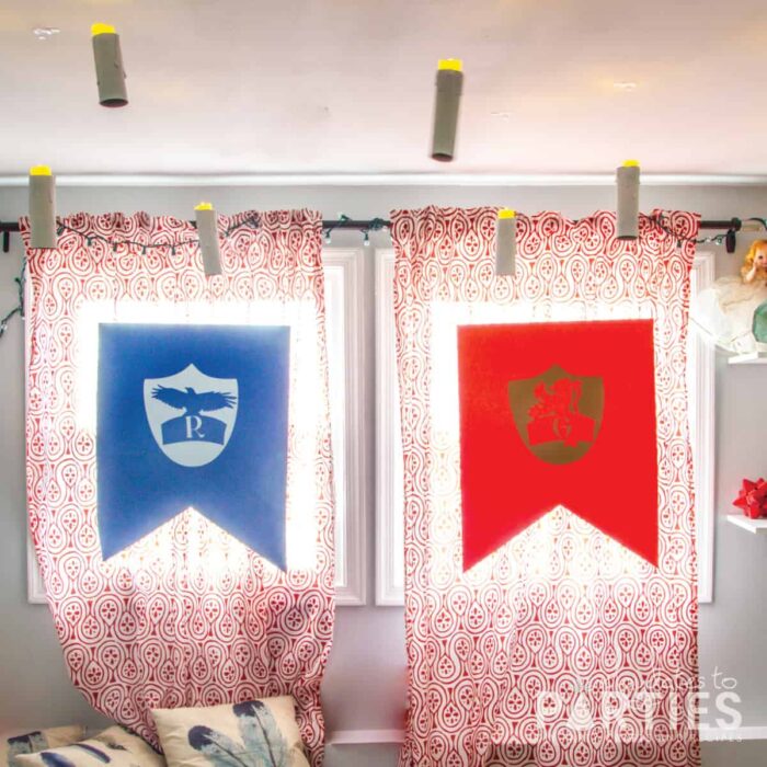 DIY Hogwarts house banners floating in front of windows with floating candles above