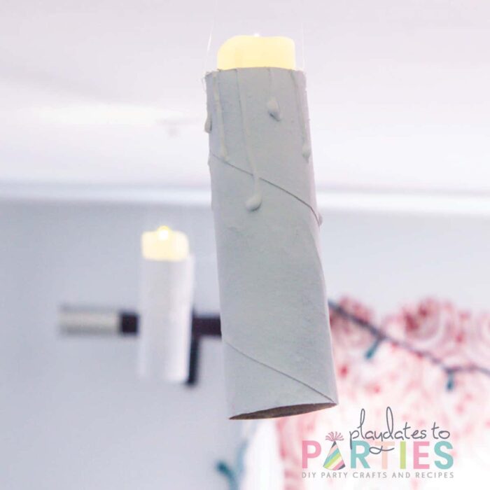 close up of a floating candle made from a toilet paper tube