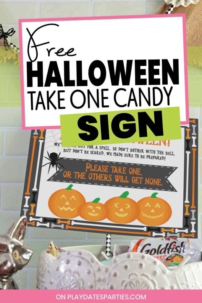 photo of a bowl of candy with a sign sticking out and the text free Halloween take one candy sign