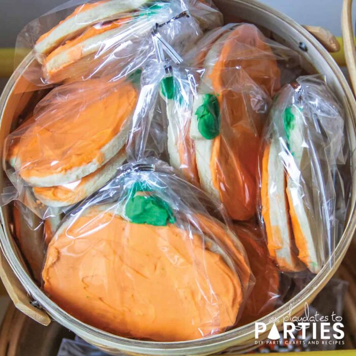 pumpkin shaped sugar cookies wrapped in favor bags