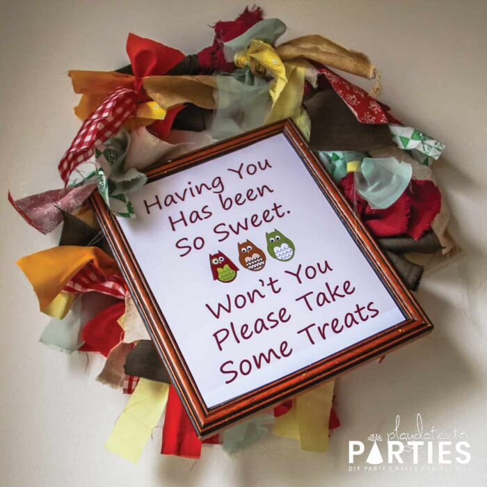 Rag wreath with a sign saying having you has been so sweet. Won't you please take some treats