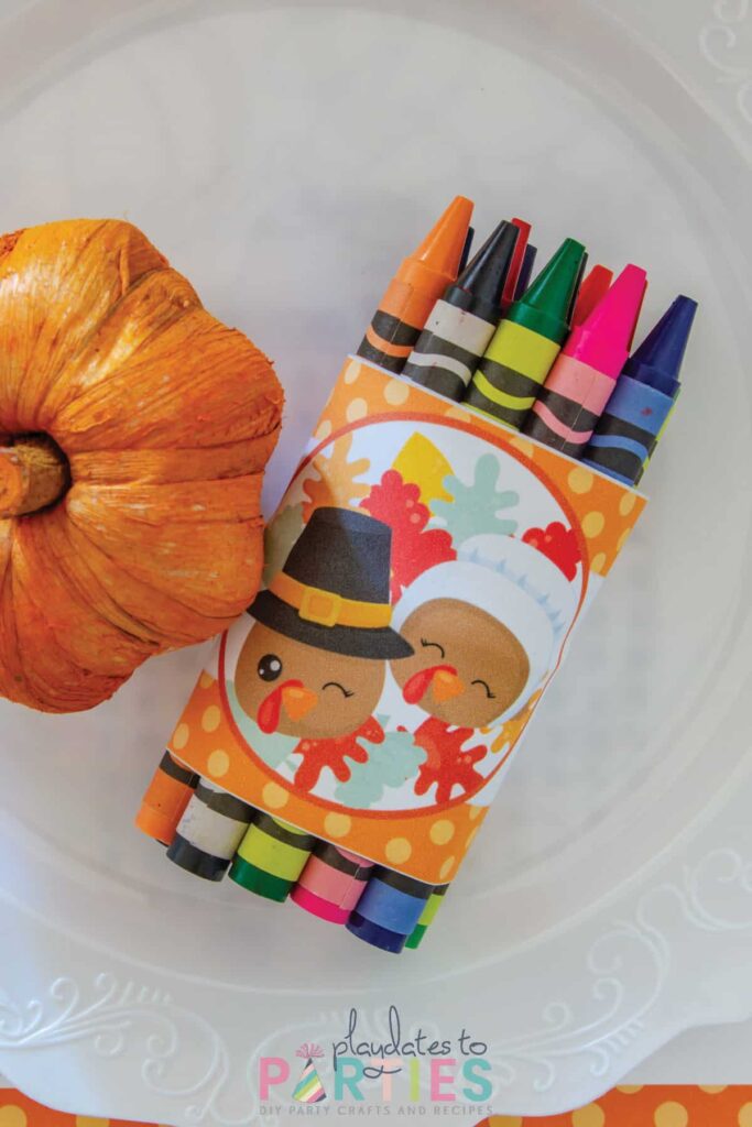 close up off a bundle of crayons wrapped with a Thanksgiving band.