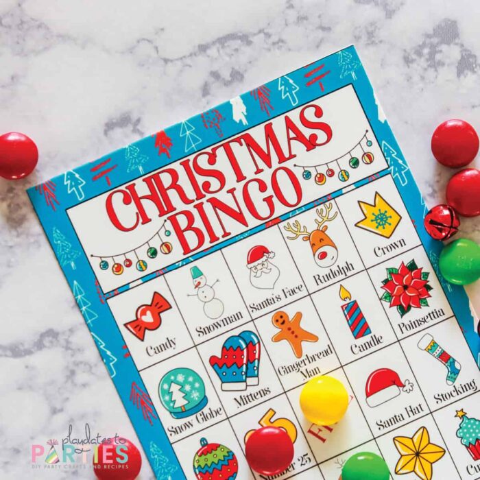 close up of a Christmas bingo card with colorful illustrations and captions in each square