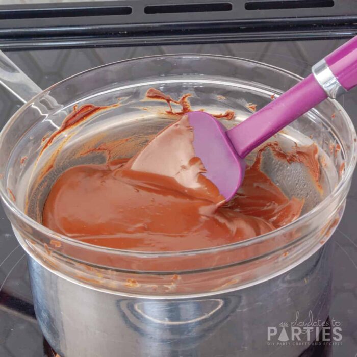Melted chocolate in a double boiler on a stovetop