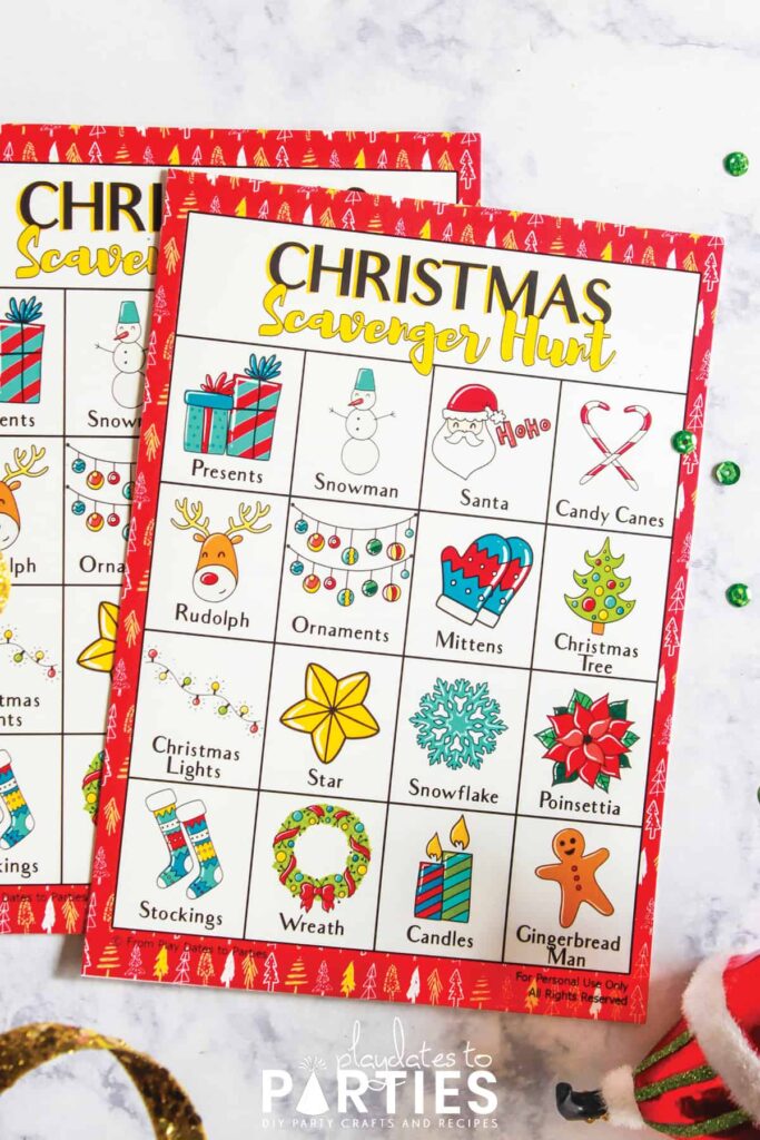 two Christmas scavenger hunt cards on a marble table top