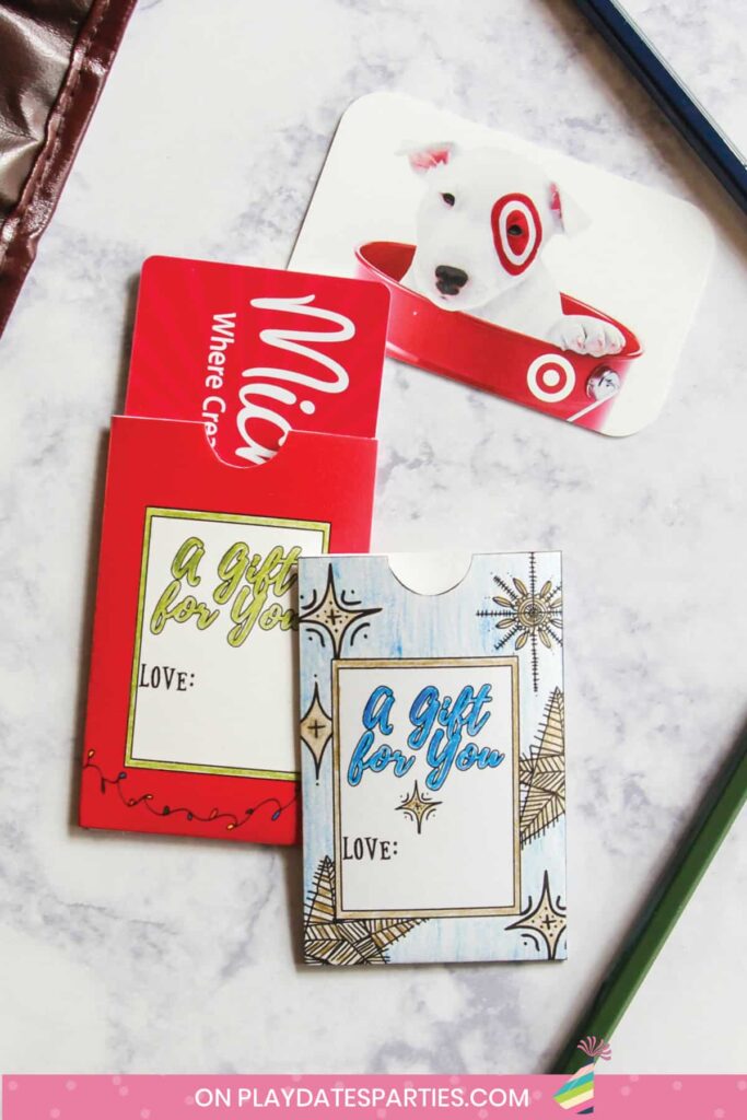 two gift card holders on a marble table with gift cards to Michaels and Target