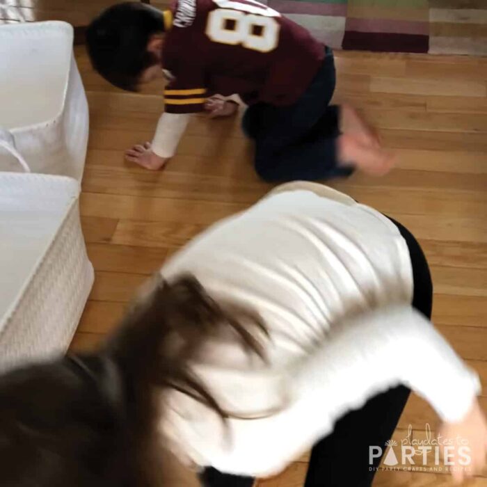 photo of kids playing a game crawling on the floor