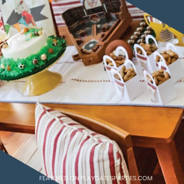 wood table with a dessert table setup and chair in front with a red and white striped pillow