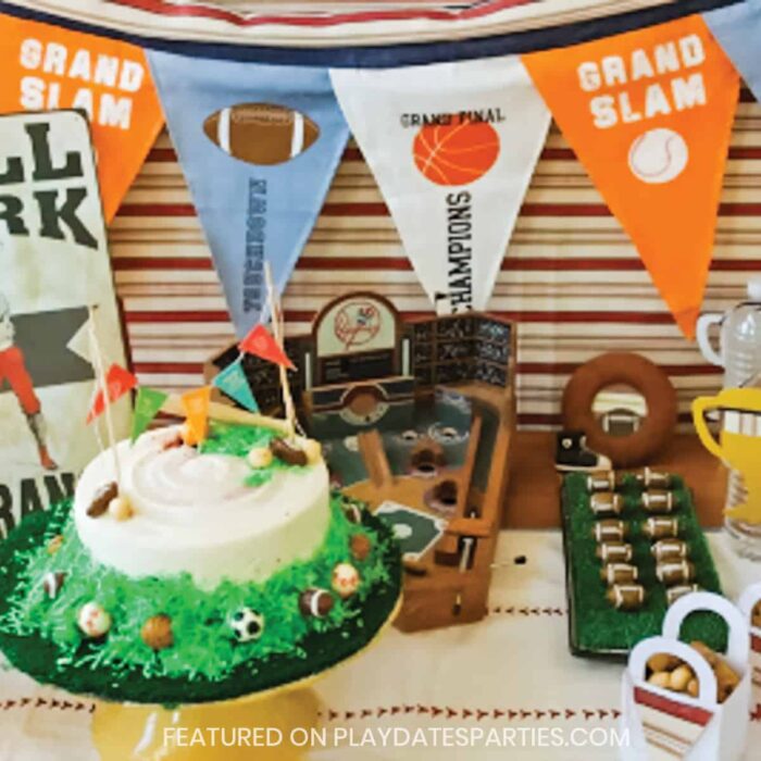 sports birthday party setup with cake, fabric banner, and mini football candies