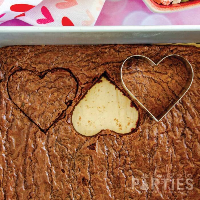 cutting brownies with a heart shaped cookie cutter