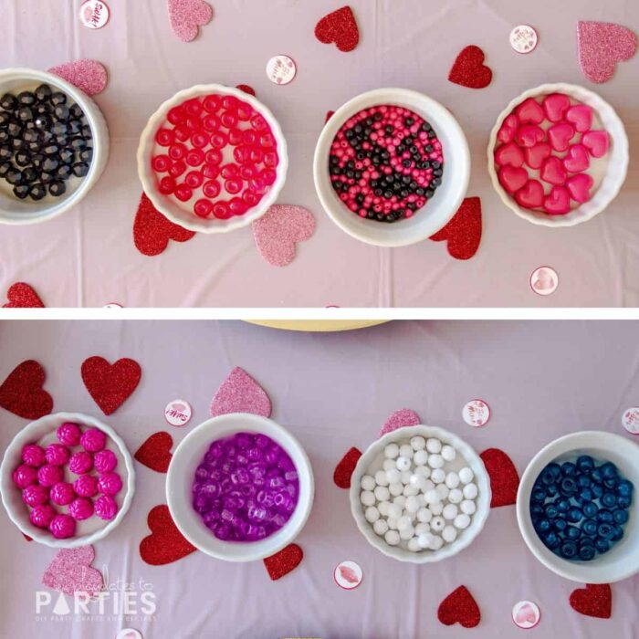 Overhead view of ramekins filled with beads on a pink table surrounded by glittery hearts and small party circles.