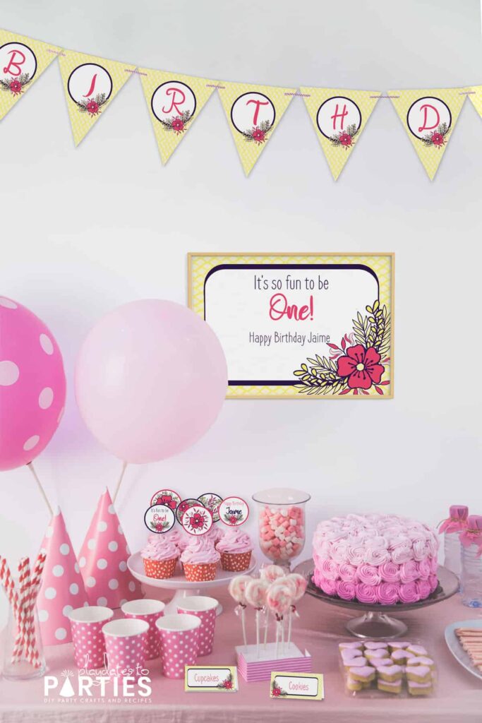 party dessert table with pink balloons and decorations with yellow and pink party printable banners, sign, cupcake toppers, and food labels