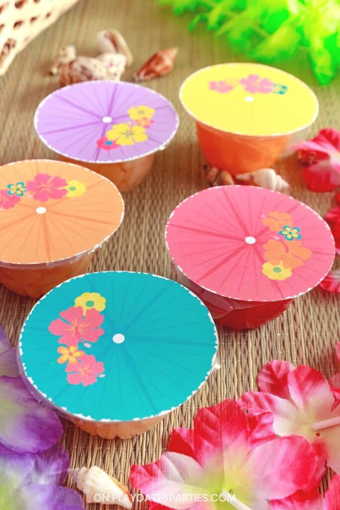 side view of fruit cups with labels that look like tropical drink umbrellas in a variety of luau colors