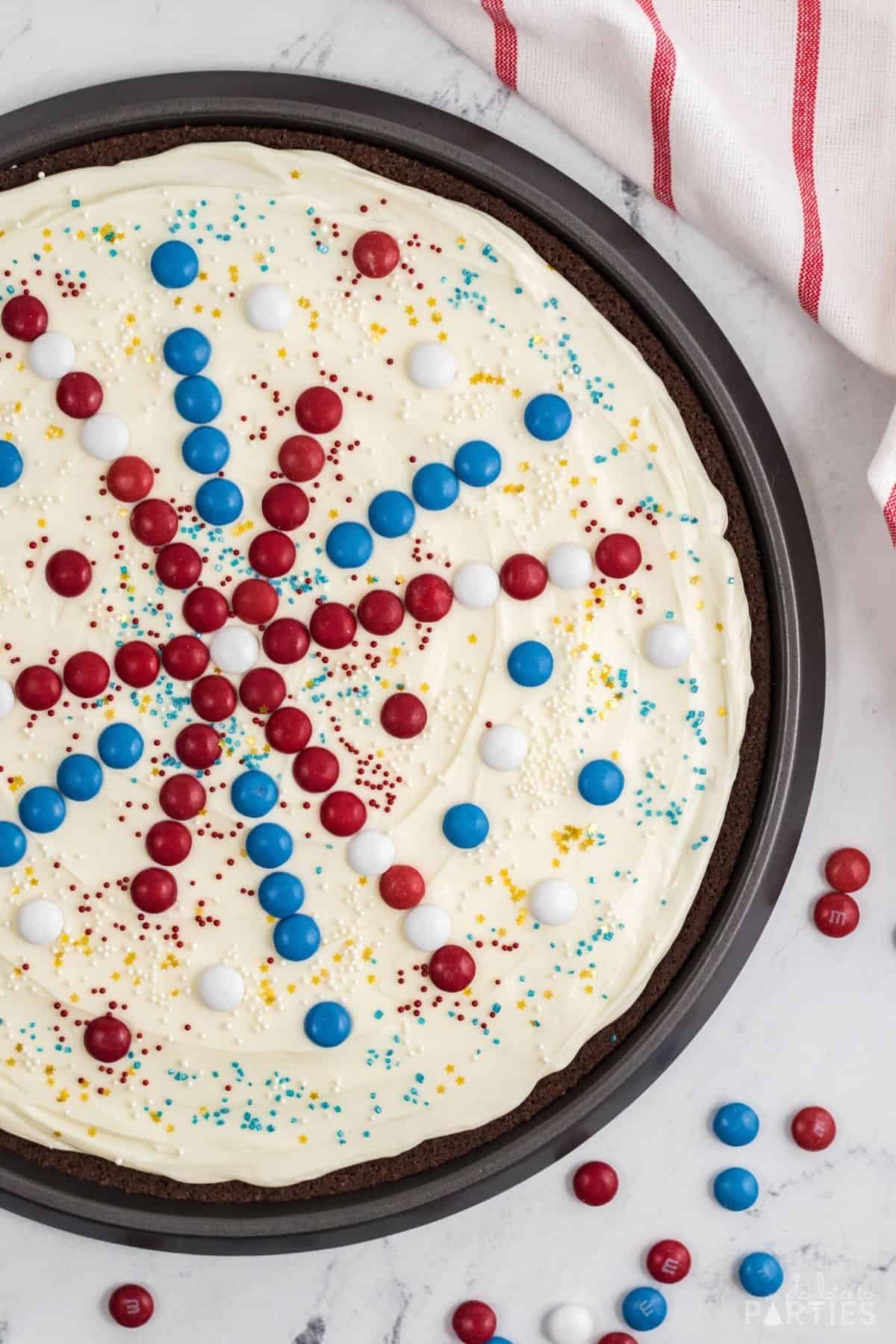 Overhead view of a finished and decorated July 4th brownie pizza.