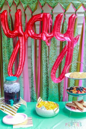 teal and dark pink party display with balloon letters YaY.