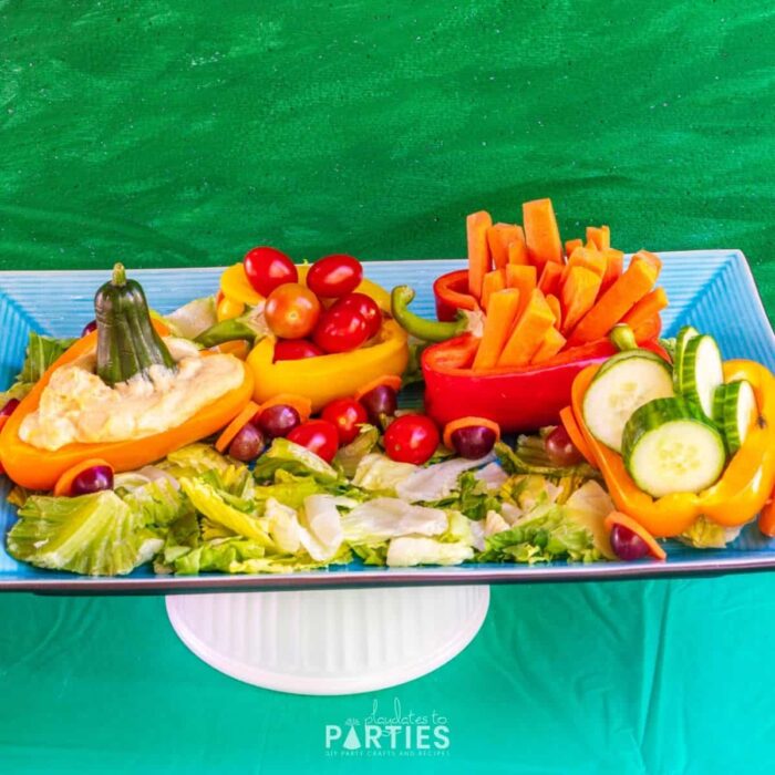 veggie platter that looks like a train with bell peppers as train cars and carrots as wheels