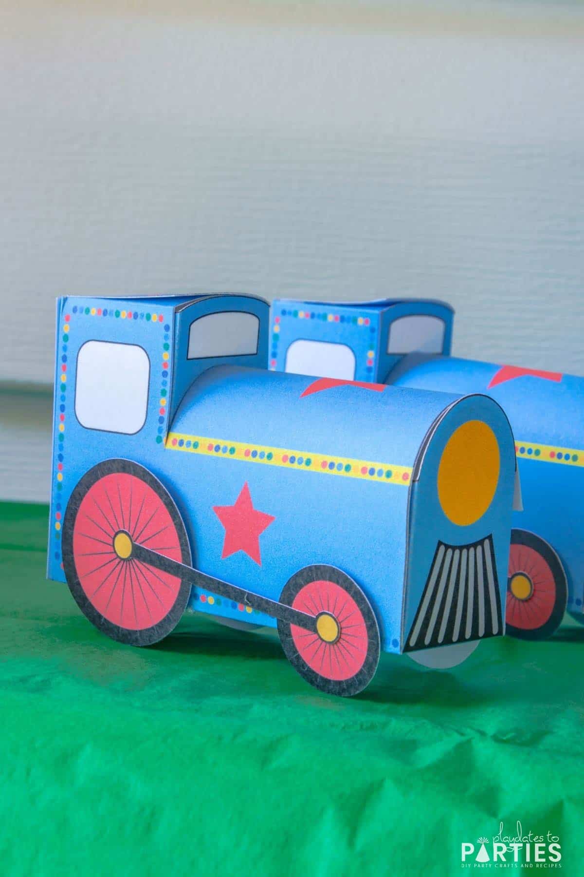 closeup of a three dimensional favor box that looks like a blue train