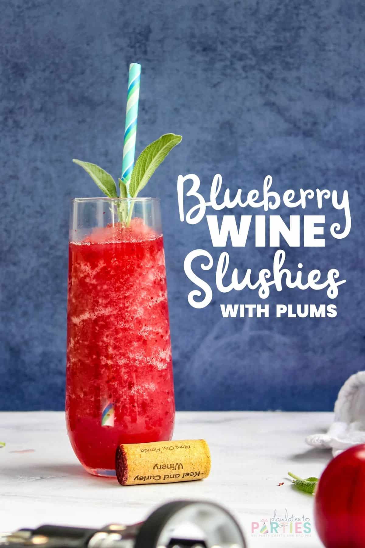 Colorful slushie in a stemless champagne flute on a marble surface with text overlay blueberry wine slushies with plums